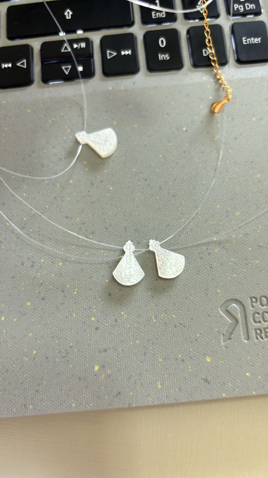 C.O fio de nylon N. sra. Ap. madre perola